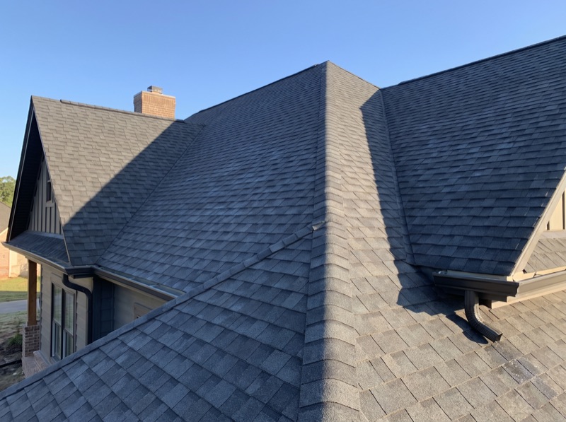 Newly installed charcoal architectural shingle roof on a single-family home