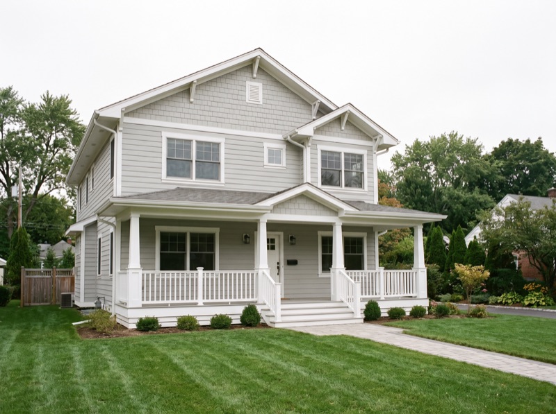 Two-story home with new light gray lap siding and white trim