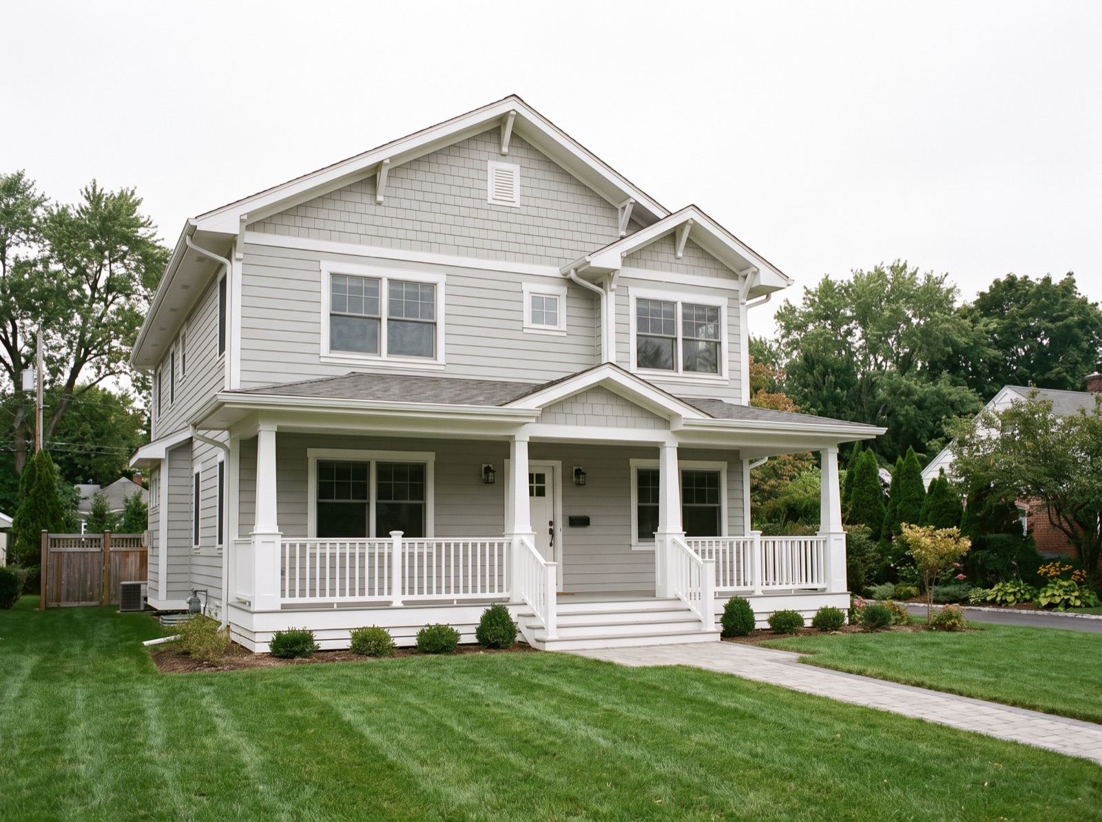 Two-story home with new light gray lap siding and white trim